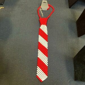 Red and white pearl neck tie necklace.